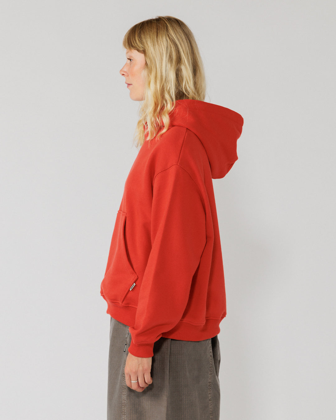 520 Organic Hoody - Signal Red — women's side, sleeve drape