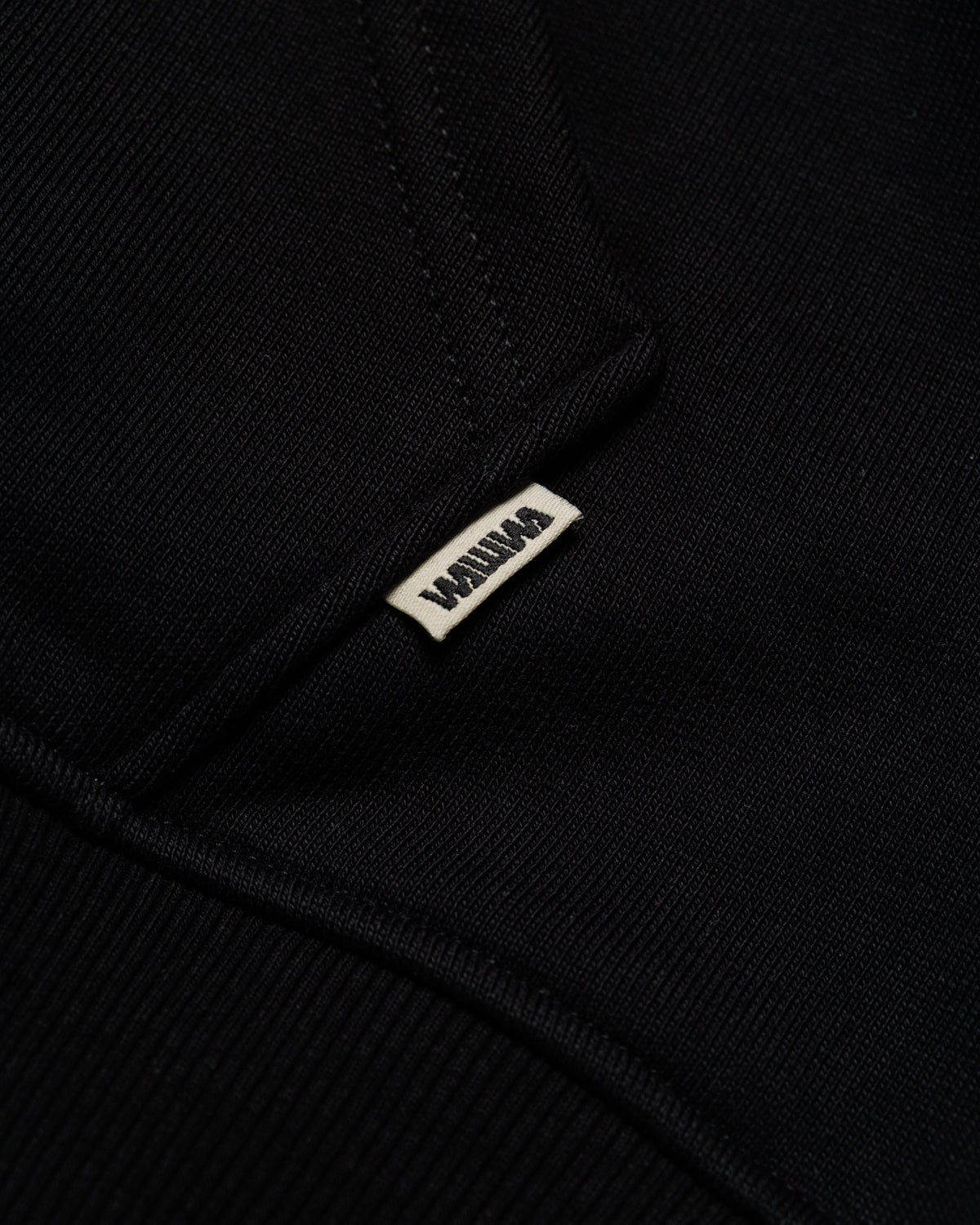 Heavyweight Two-Way Zip Hoody - Black — Hem label branding detail