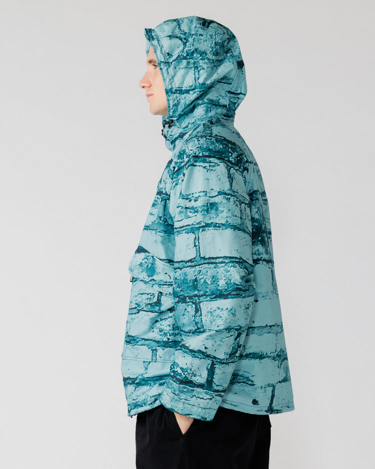 Roam Raglan Jacket - Blue Brick Camo — hood up, side profile