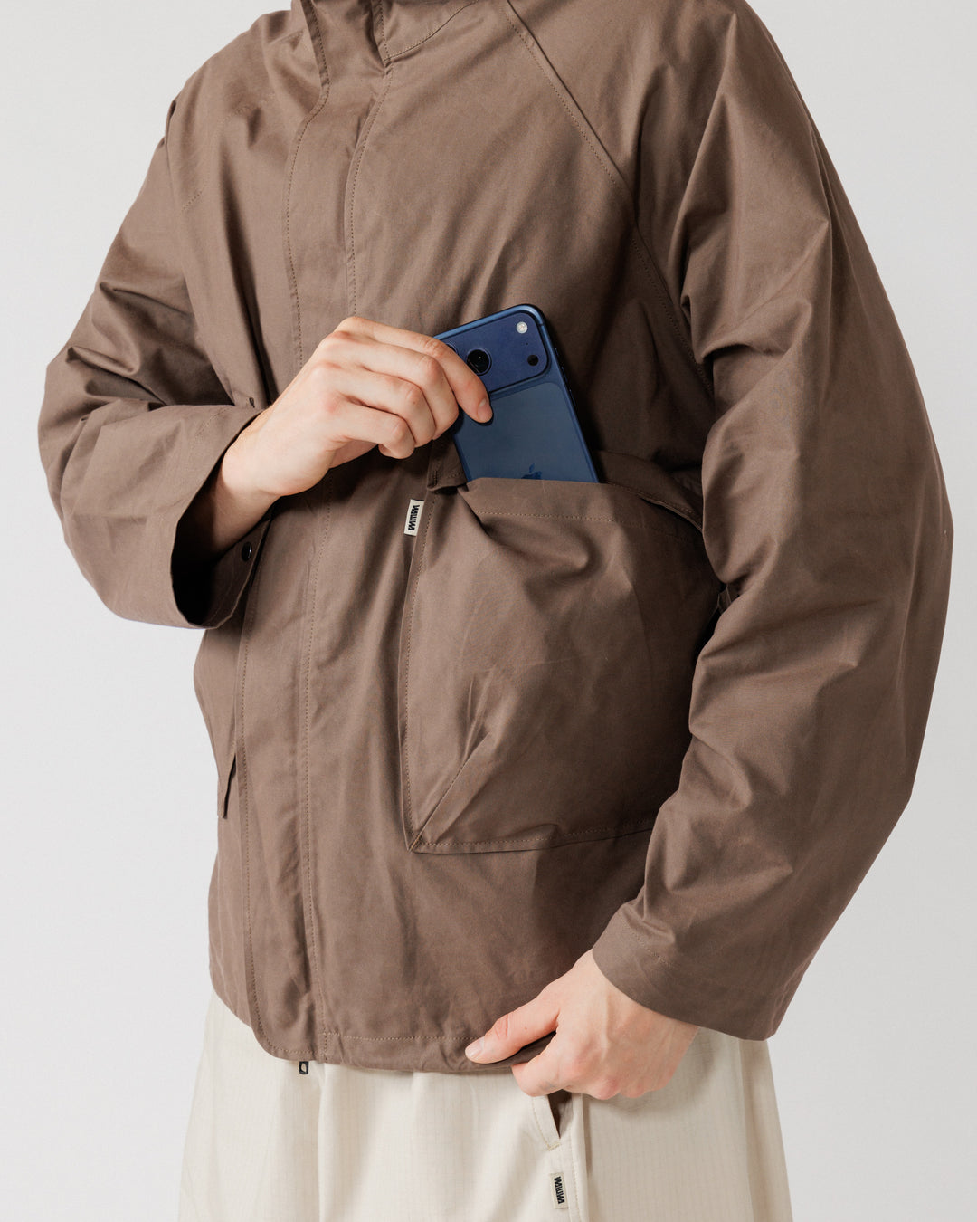 Roam Raglan Jacket - Bracken — flap pocket capacity demo