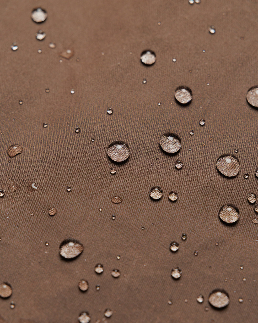 Roam Raglan Jacket - Bracken — water beading proves weatherproofing