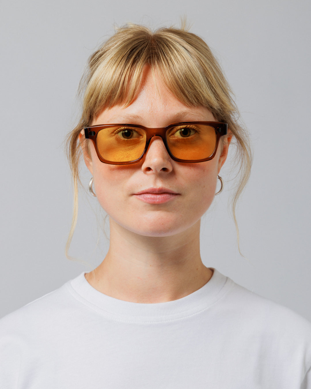 Female model wearing Solaris Sunglasses in coconut, front view