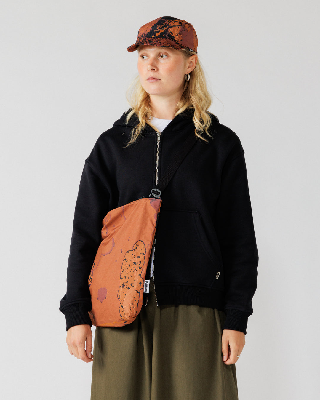 Water Resistant Messenger Bag - Abstract Brick Camo — worn cross-body front, best framing