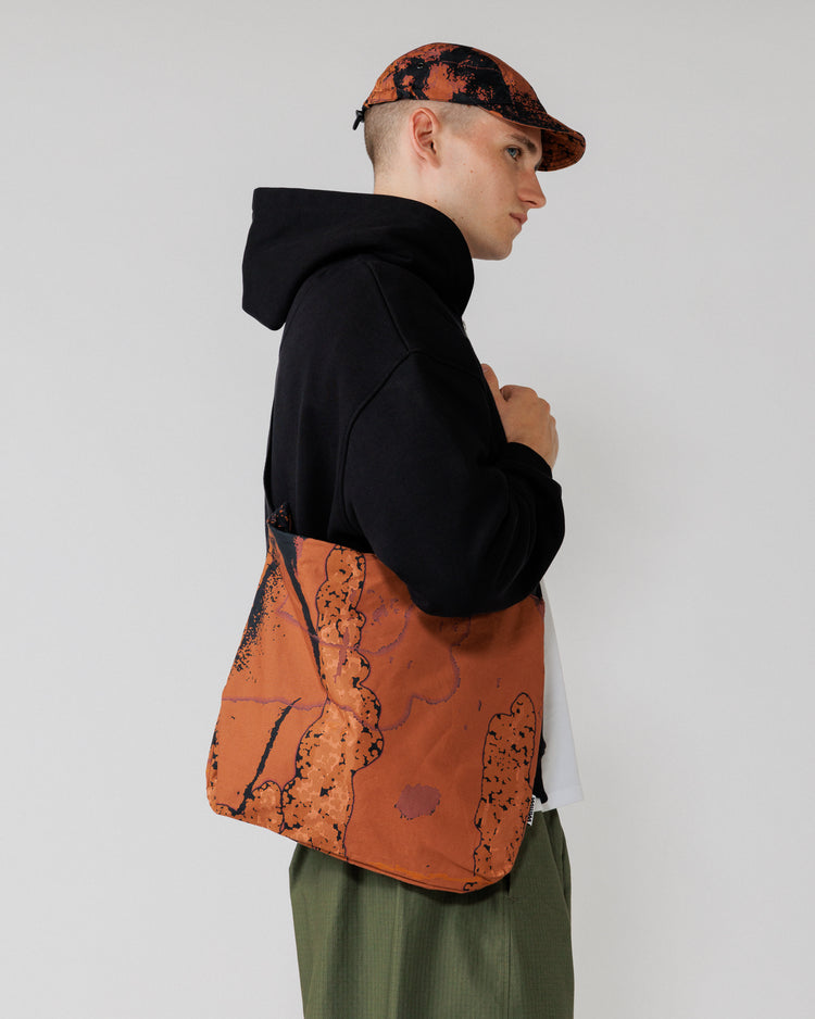 Water Resistant Messenger Bag - Abstract Brick Camo — side view, bag drape clearest